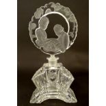 A glass scent bottle flask / the stopper with moulded decoration depicting a young couple.