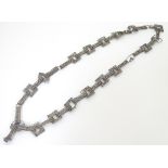 A Continental white metal necklace formed with filigree work links.