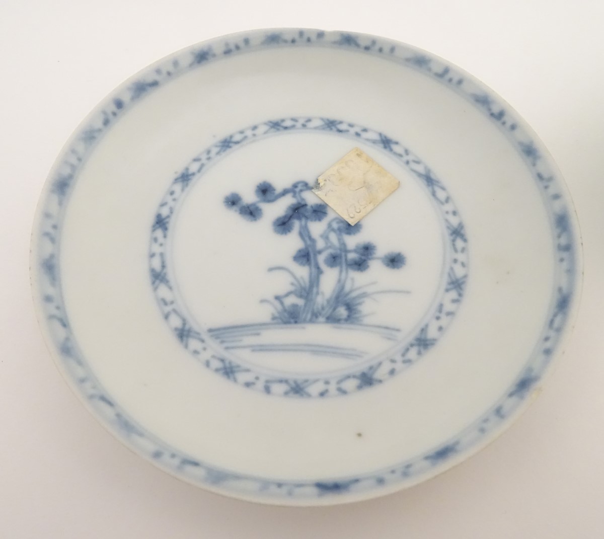 An 18thC Chinese Nanking Cargo blue and white tea bowl and saucer, decorated with pine trees. - Image 8 of 10