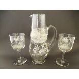 A souvenir glass jug and two wine glasses decorated with etched detail titled ' A Present from