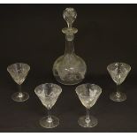 A Victorian globular decanter with etched floral decoration, together with four matching glasses.