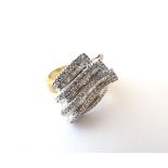 A 9ct gold dress ring set with a profusion of brilliant and baguette cut diamonds. Rind size approx.