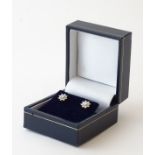 A pair of 9ct gold earrings set with diamond clusters.