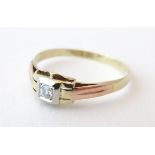 A gold ring set with central diamond in a squared Art Deco setting, the diamond approx. 0.25ct.