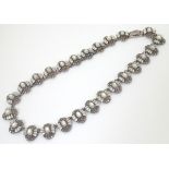 A silver necklace formed from 25 vignettes each set with a profusion of marcasites and with catseye