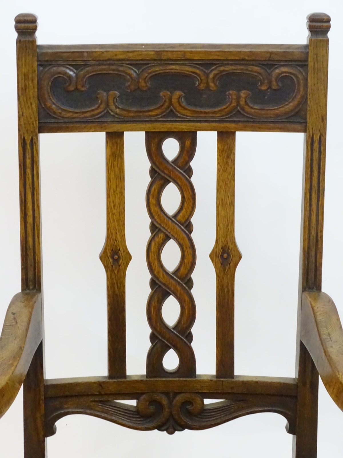 An early 20thC oak open armchair with a Celtic style carved top rail and back ress, - Image 4 of 8