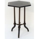 A late 19thC ebonised Aesthetic movement coromandel table with a hexagonal top,