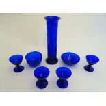 7 assorted items of blue glass comprising drinking glasses, dish, vase etc.