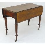 A late 19thC mahogany Pembroke table with a single end drawer and raised on turned tapering legs