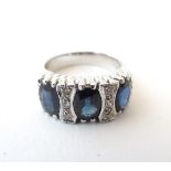 An 18ct white gold ring set with 3 oval sapphires and six diamonds. Ring size approx.