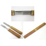 A 20thC campaign / picnic knife and fork cutlery set, each utensil having wooden with brass collars.