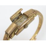 A 20thC gold plated bangle formed wristwatch with sprung hinged central section,