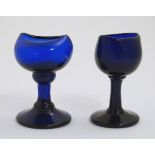 Two late 19th C blue glass pedestal eye baths. Tallest 3" high.