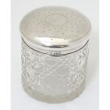 A cut glass dressing table jar with silver top hallmarked Birmingham 1915 maker S Blanckensee &
