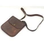A leather messenger bag with a postmans lock clasp and an adjustable shoulder strap. Approx.