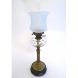 An early 20thC Duplex oil lamp, with opaque glass shade,