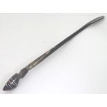 A horn shoe horn surmounted by a carved stylised head with inlaid detail. Approx. 19" long.