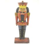 A cast iron door stop formed as a nutcracker soldier with painted details. Approx.