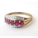 A 9ct gold ring set with 5 rubies in a linear setting flanked by chip set diamonds.