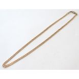 A 9ct gold flat curb link chain. Approx. 20" long.