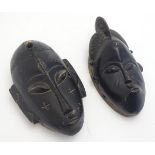 Ethnographic / Native / Tribal: A pair of ebonised wall masks with carved decoration. Each approx.