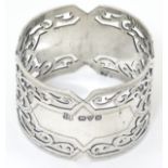 A silver napkin ring with pierced decoration hallmarked Chester 1912 Barker Brothers.