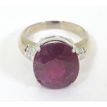 An 18ct white gold ring set with large oval red spinel flanked by diamonds. Ring size approx.