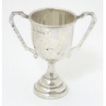 A silver trophy cup of pedestal form with twin handles. Birmingham 1936 maker G Bryan & Co.