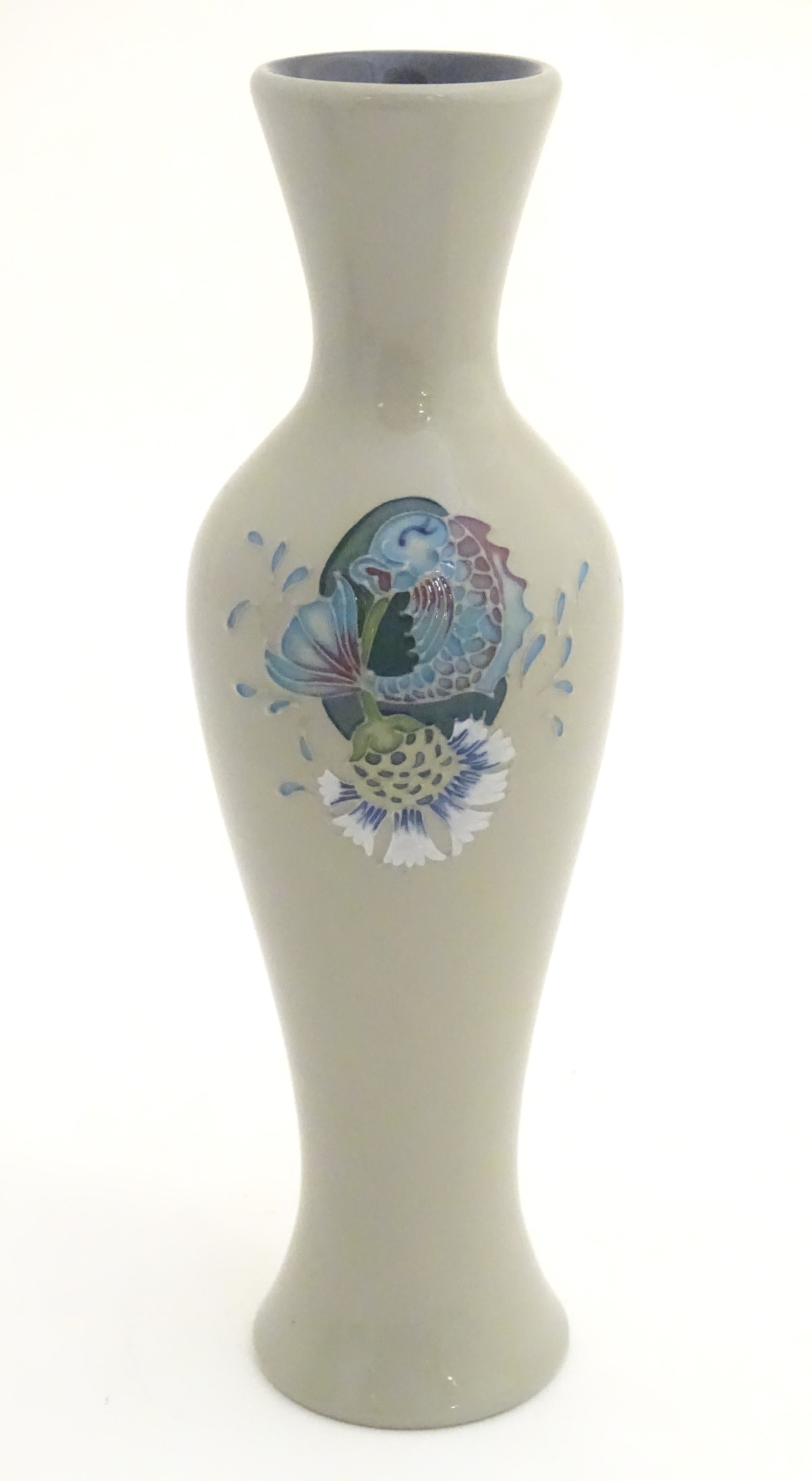 A Moorcroft vase in the shape no. 93/12 decorated with a fish and thistle design.