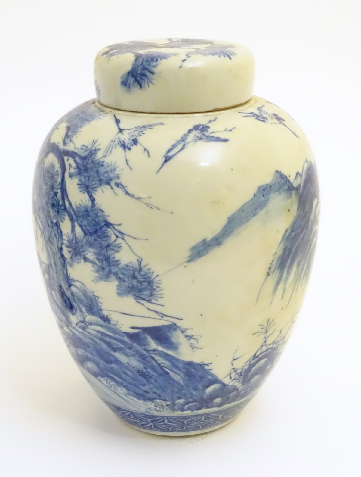 A large blue and white Japanese lidded ginger jar decorated with a sage sat by a tree in a - Image 2 of 7