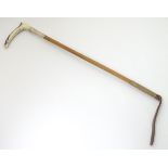 A 20thC antler handled riding crop with a malacca shaft and silver collar,