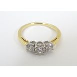 An 18ct gold ring set with trio of diamonds. Ring size approx. N.