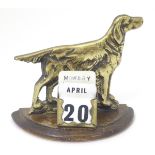 A desk calendar with a brass setter / pointer dog. approx. 4" high.