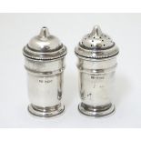A pair of silver salt and pepper pots hallmarked Sheffield 1936 maker Viner's Ltd.