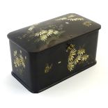 A Victorian papier mache black lacquer finished two sectional tea caddy decorated with daisy
