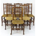 A set of six fruitwood spindle back chairs with carved cresting rails,