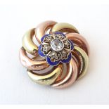 A 19thC 15ct yellow and rose gold brooch with blue enamel detail and central diamond.