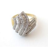 A 9ct gold dress ring set with a profusion of brilliant and baguette cut diamonds. Ring size approx.