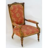 A mid 19thC walnut open armchair with a fretwork carved cresting rail and back rest,