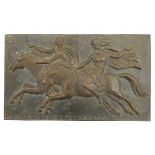 A bronze relief plaque depicting two figures riding galloping horses,