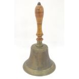 A 19th / 20thC large hand bell with a turned wooden handle and incised banded decoration. Approx.