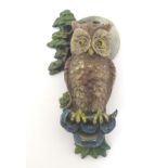 A 20thC painted brass door knocker formed as an owl with tree and moon decoration. Approx.