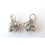 A pair of silver novelty pendant charms formed as elephants. Approx.