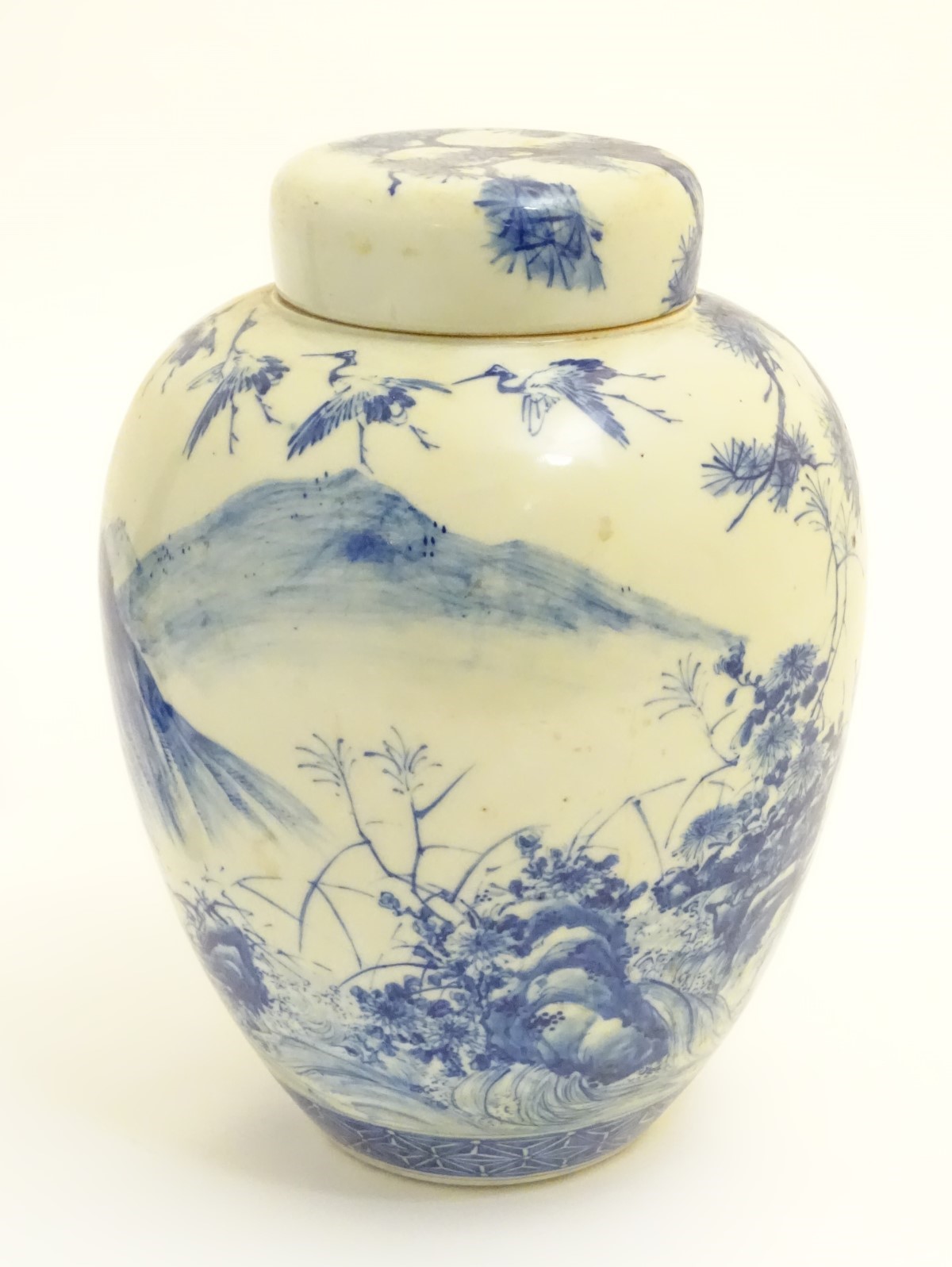 A large blue and white Japanese lidded ginger jar decorated with a sage sat by a tree in a - Image 4 of 7