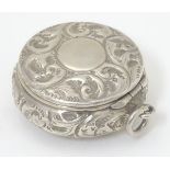 An early 20thC silver compact of pot form, with embossed acanthus scroll decoration and hinge lid,