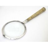 A silver magnifying glass with shagreen covered handle.