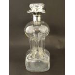 A glass decanter with pinch waist detail and silver rim hallmarked Birmingham 1906. 11" high