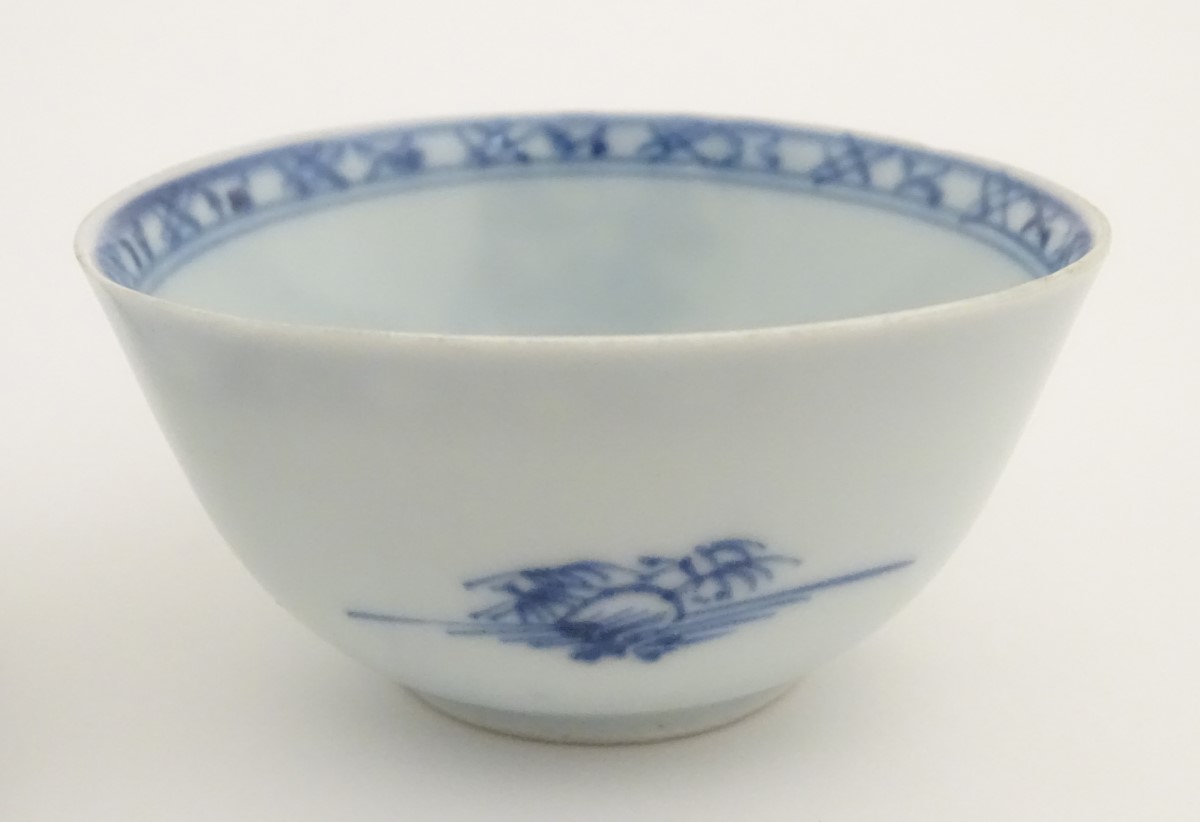 An 18thC Chinese Nanking Cargo blue and white tea bowl and saucer, decorated with pine trees. - Image 6 of 10