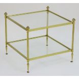 A 20thC two tier gilt brass and glass coffee table standing on turned tapering feet.