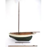 Toy: An early 20thC painted wooden toy boat / pond yacht. Approx. 22" long.